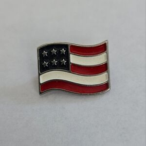 Red and White Jewelry Pin with Fluttering Flag Design
